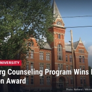 University Hall, a red brick building with a tall tower on the Heidelberg University campus in Tiffin, with headline: Heidelberg Counseling Program Wins Regional Innovation Award